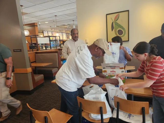 Volunteers preparing gift bags for the tournament at COMEC’s 2026 golf tournament