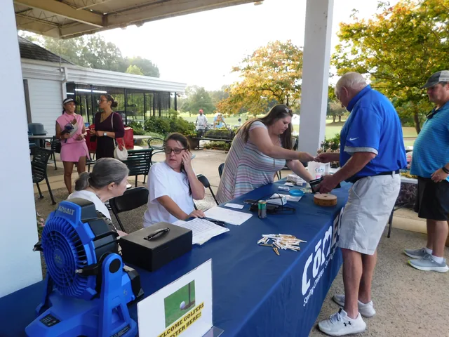 Golfers checking in at the COMEC registration table at COMEC’s 2026 golf tournament