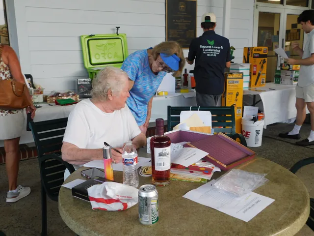 Volunteers preparing registration materials at COMEC’s 2026 golf tournament