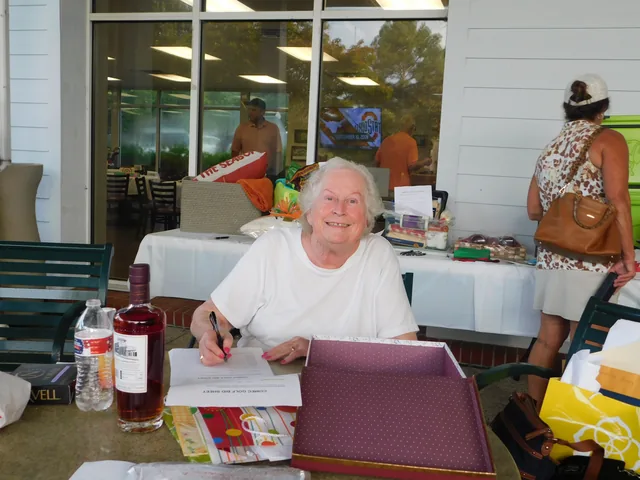 A volunteer welcoming participants at the clubhouse at COMEC’s 2026 golf tournament