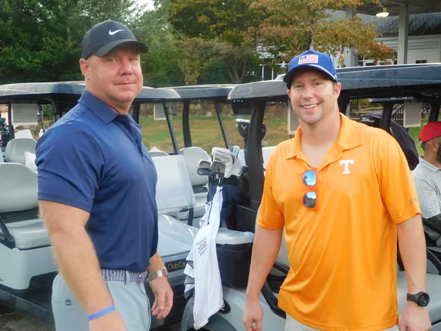 Two golfers beside their cart at COMEC’s 2026 golf tournament