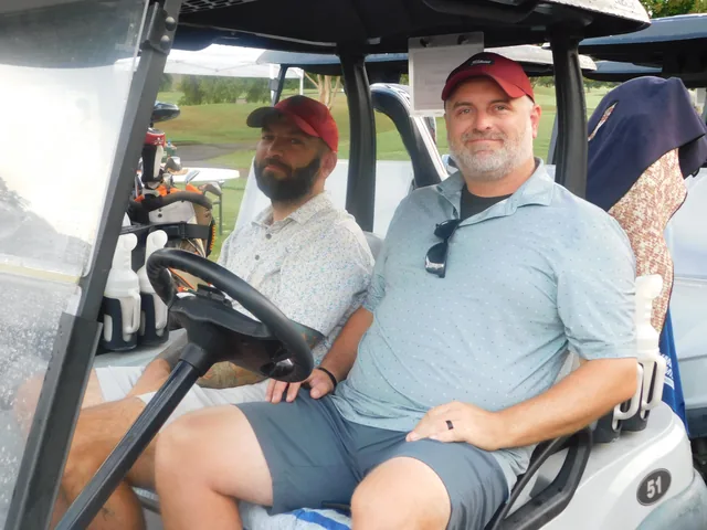 Golfers seated in their cart before play at COMEC’s 2026 golf tournament