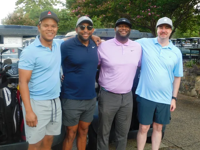 A four-person team beside the golf carts at COMEC’s 2026 golf tournament