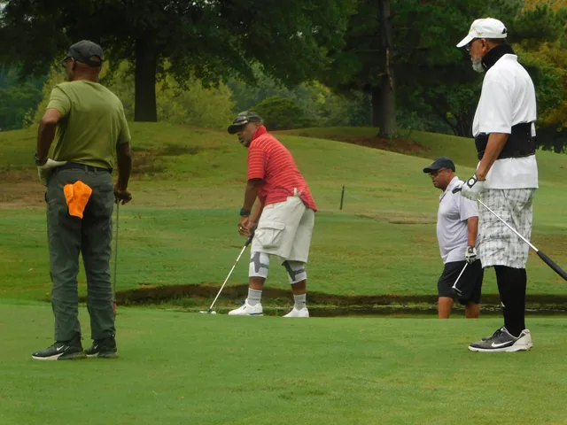 Players watching a shot on the course at COMEC’s 2026 golf tournament