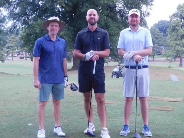 Three golfers together between shots at COMEC’s 2026 golf tournament