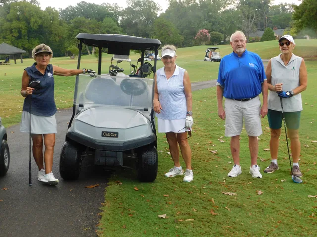A group of golfers beside their cart at COMEC’s 2026 golf tournament