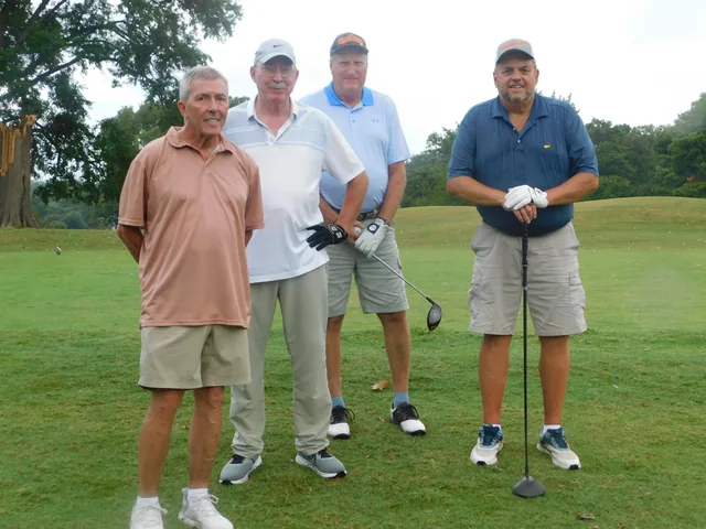 A four-person team standing together on the course at COMEC’s 2026 golf tournament