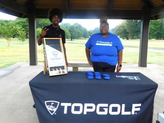 Representatives at the Topgolf display table at COMEC’s 2026 golf tournament