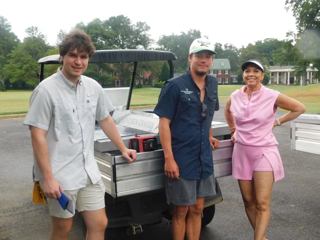 Three golfers beside their cart at COMEC’s 2026 golf tournament