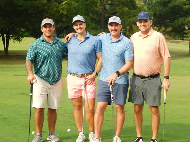 A team holding their clubs on the course at COMEC’s 2026 golf tournament