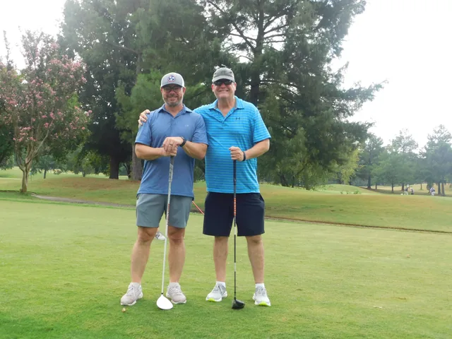 Two golfers together on the course at COMEC’s 2026 golf tournament