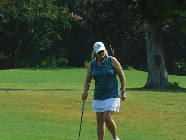 A golfer walking across the green at COMEC’s 2026 golf tournament