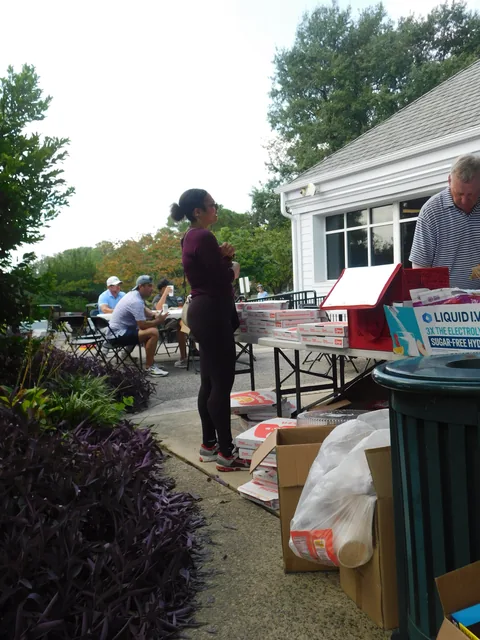 Supporters around the clubhouse patio at COMEC’s 2026 golf tournament