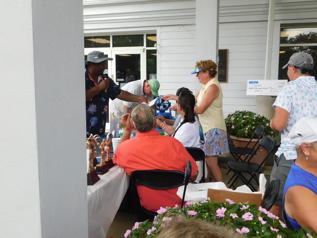 Participants gathered at the clubhouse entrance at COMEC’s 2026 golf tournament