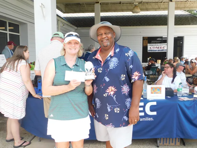 A golfer receiving an award at COMEC’s 2026 golf tournament