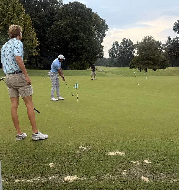 Golfers playing a shot on the green at COMEC’s 2026 golf tournament