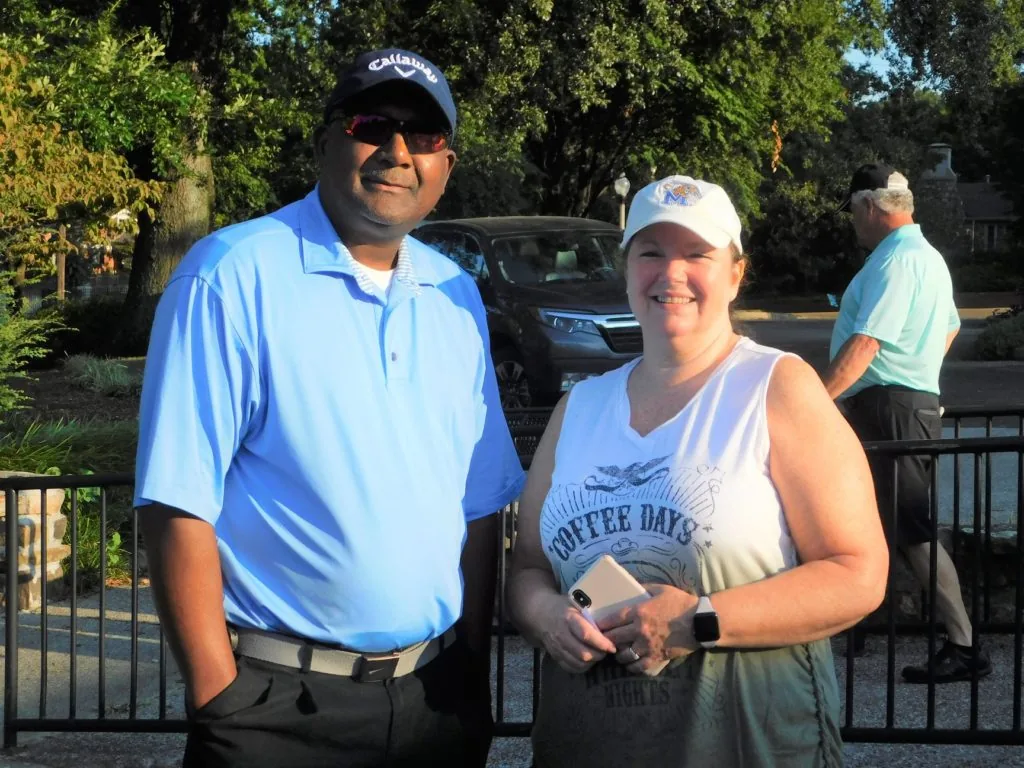 Two supporters holding an award at a COMEC Golf Tournament