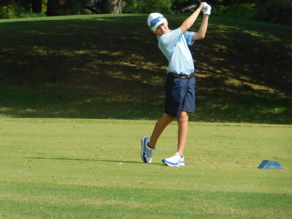 A golfer taking a tee shot during a COMEC Golf Tournament